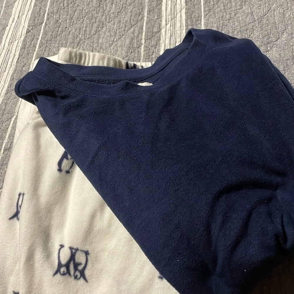 Women’s XL pajama set with penguins on the pants and a solid navy blue shirt.